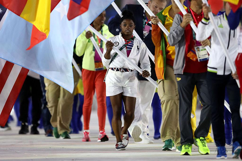 Simone Biles carrying the flag at the 2016 Olympic games