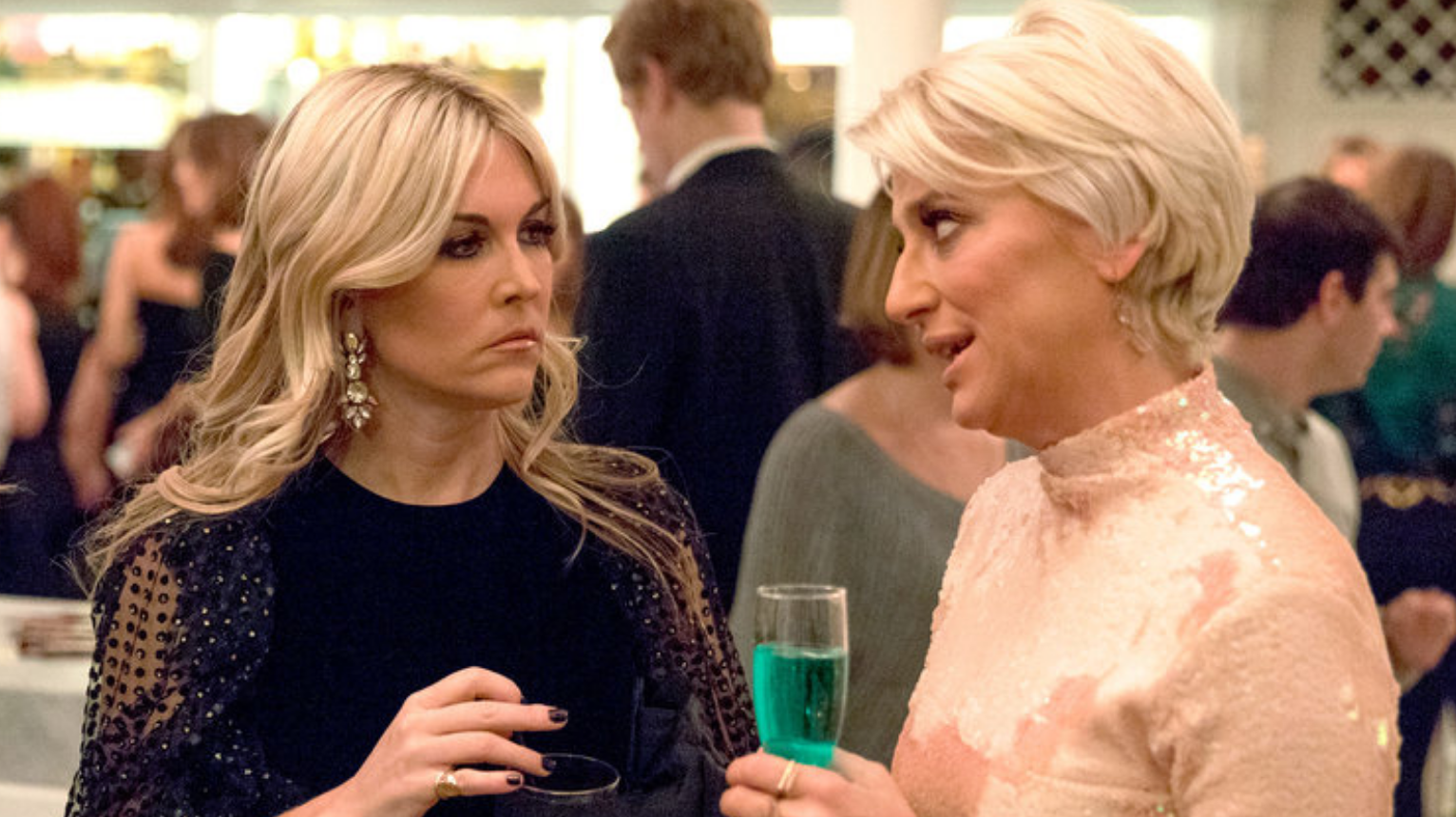 Dorinda and Tinsley talking to each other at a party. 