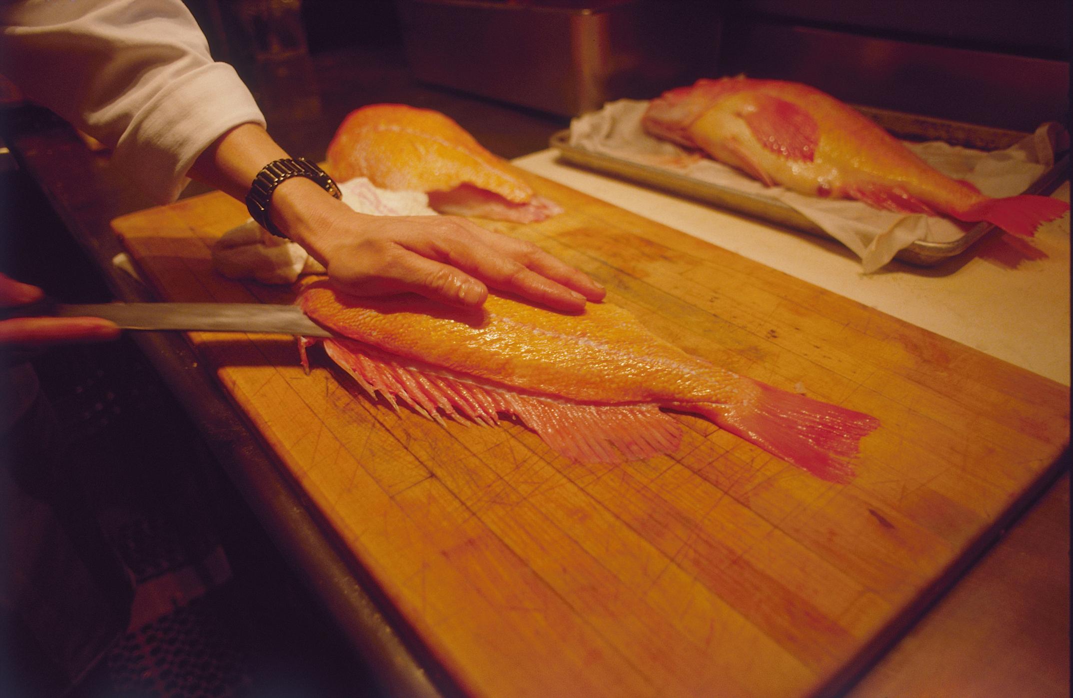 chef slicing fish