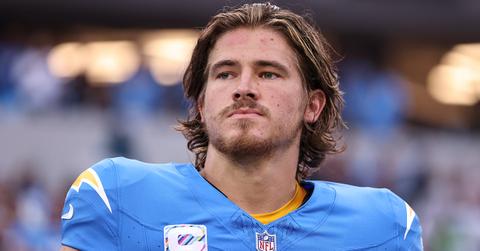 Justin Herbert with his helmet off in uniform.