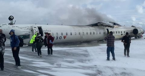 A photo of the Delta flight flipped upside down on the runway.