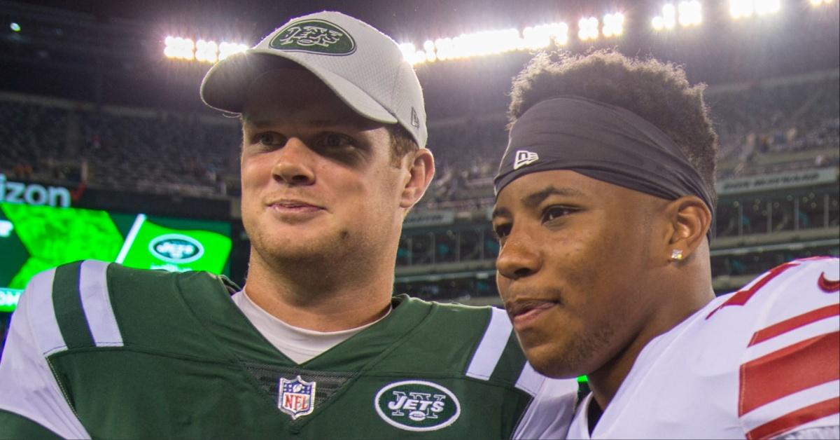 Sam Darnold and Saquan Barley poses for a picture on the football field. 