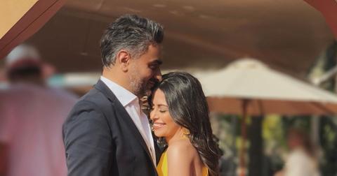 (l-r): Munaf Ali and Nina Ali embracing at an event.