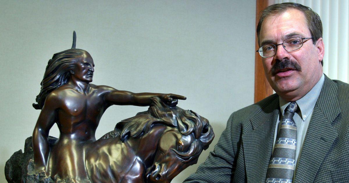 Sgt. Gary J. Swanson of the Washington County Sheriff's Department sitting next to a Crazy Horse monument model