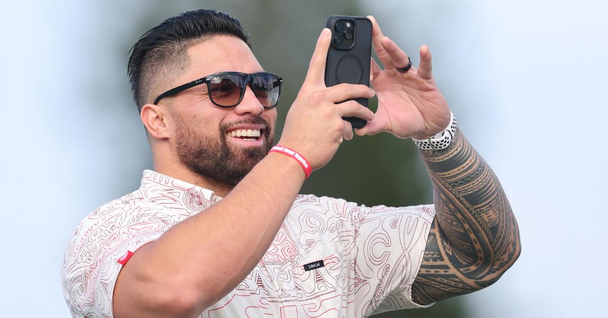  Manti Te'o takes a video on his phone at the Kapalua Golf Club on Jan. 3, 2024, in Kapalua, Hawaii.