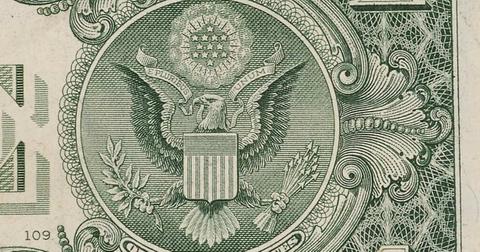 The seal of America on the back of the one dollar bill