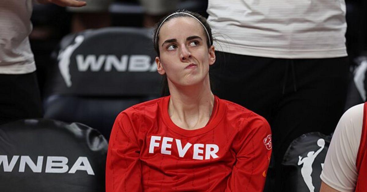 Caitlin Clark looking disappointed on the bench for the Fever. 