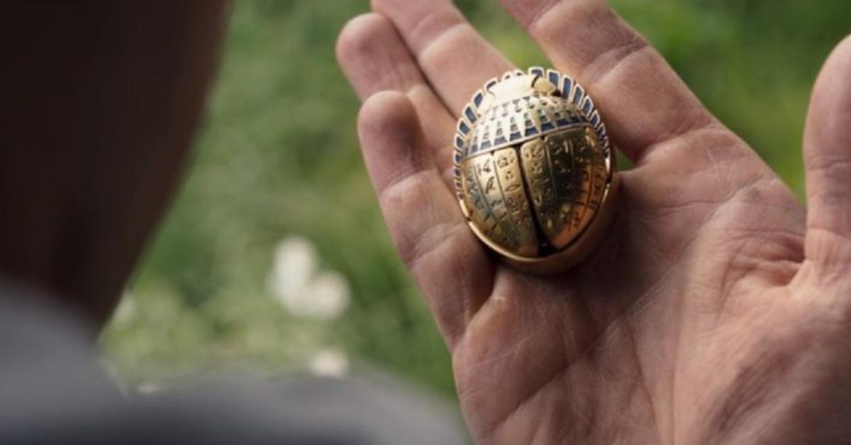 Steven looks at the golden scarab.