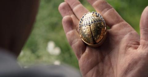 Steven looks at the golden scarab.