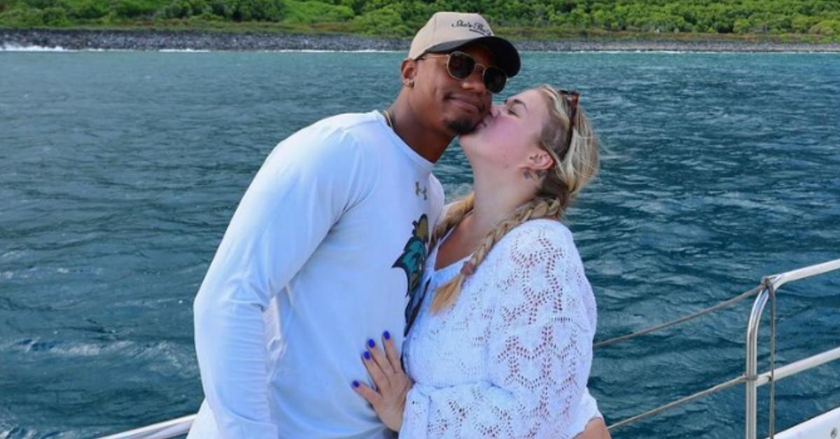 Samantha kissing her boyfriend's cheek while on a boat on the Napali Coast.