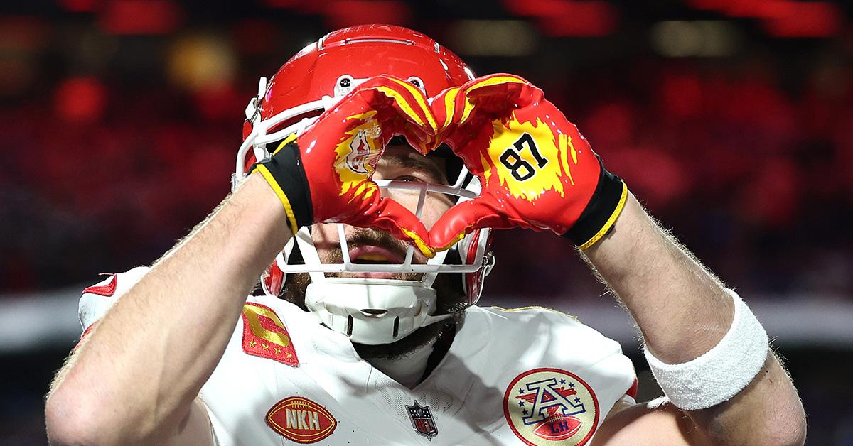 Travis Kelce making a heart with his hands after scoring a touchdown. 