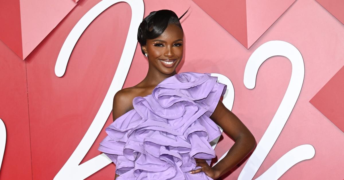 Leomie Anderson wears a purple dress with frills at The Fashion Awards 2022.