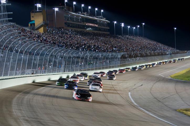 Long train of NASCAR cars racing