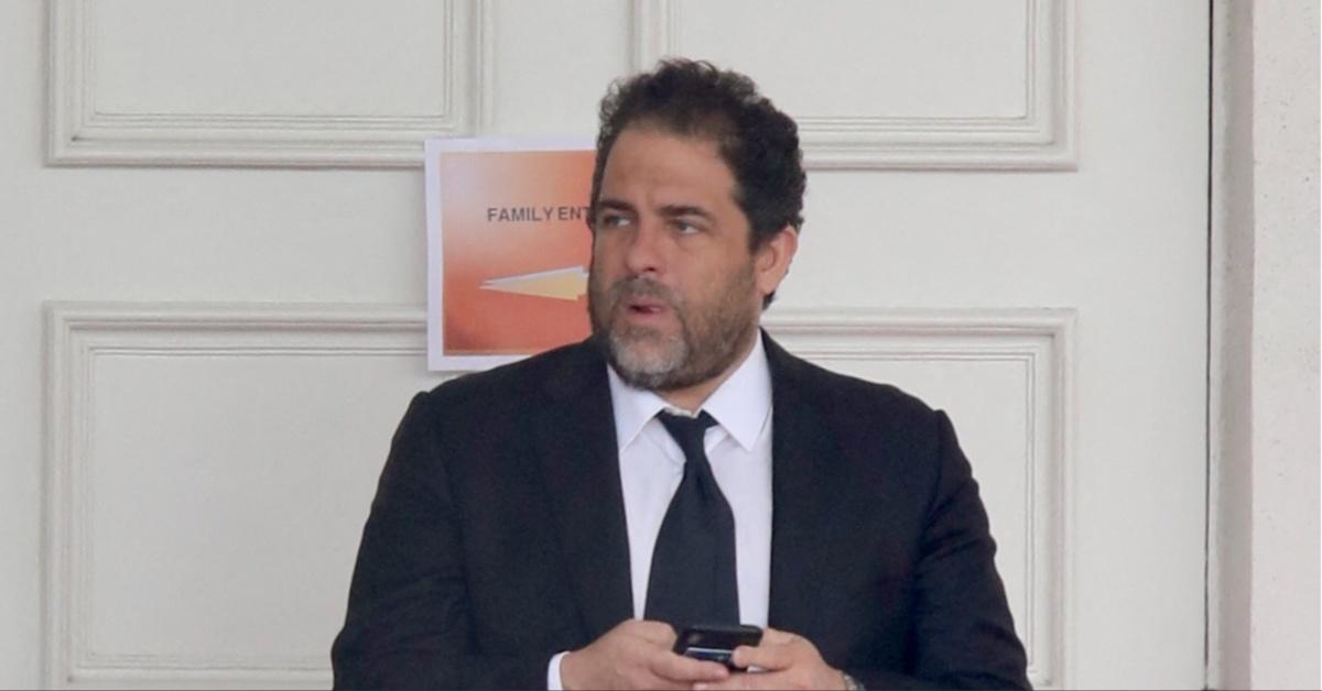 Brett Ratner uses his cell phone. 
