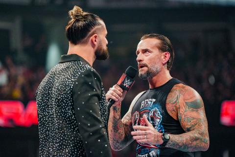 Seth Rollins and CM Punk in the ring