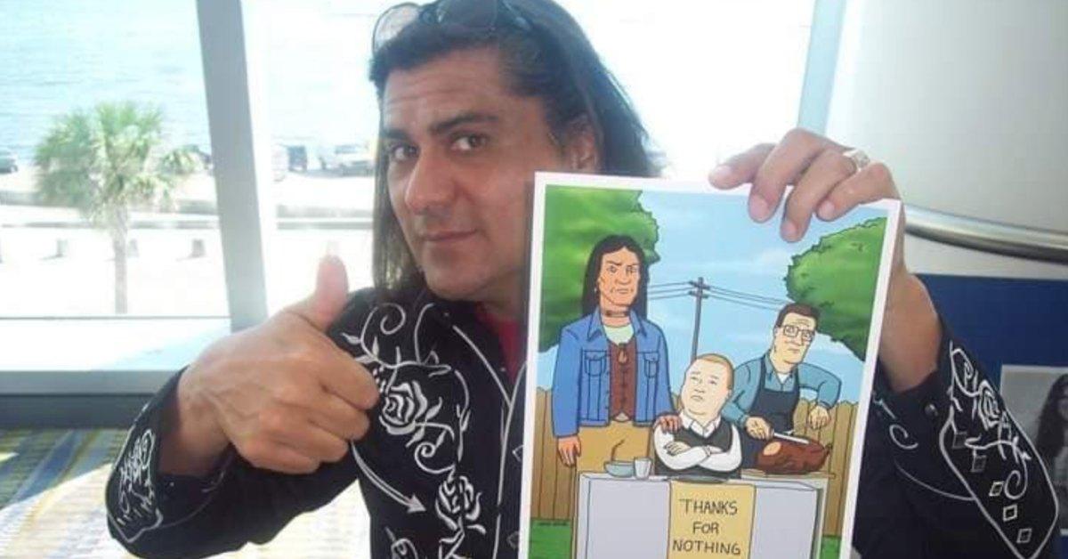 Jonathan Joss holding up a photo of his character in 'King of the Hill'.