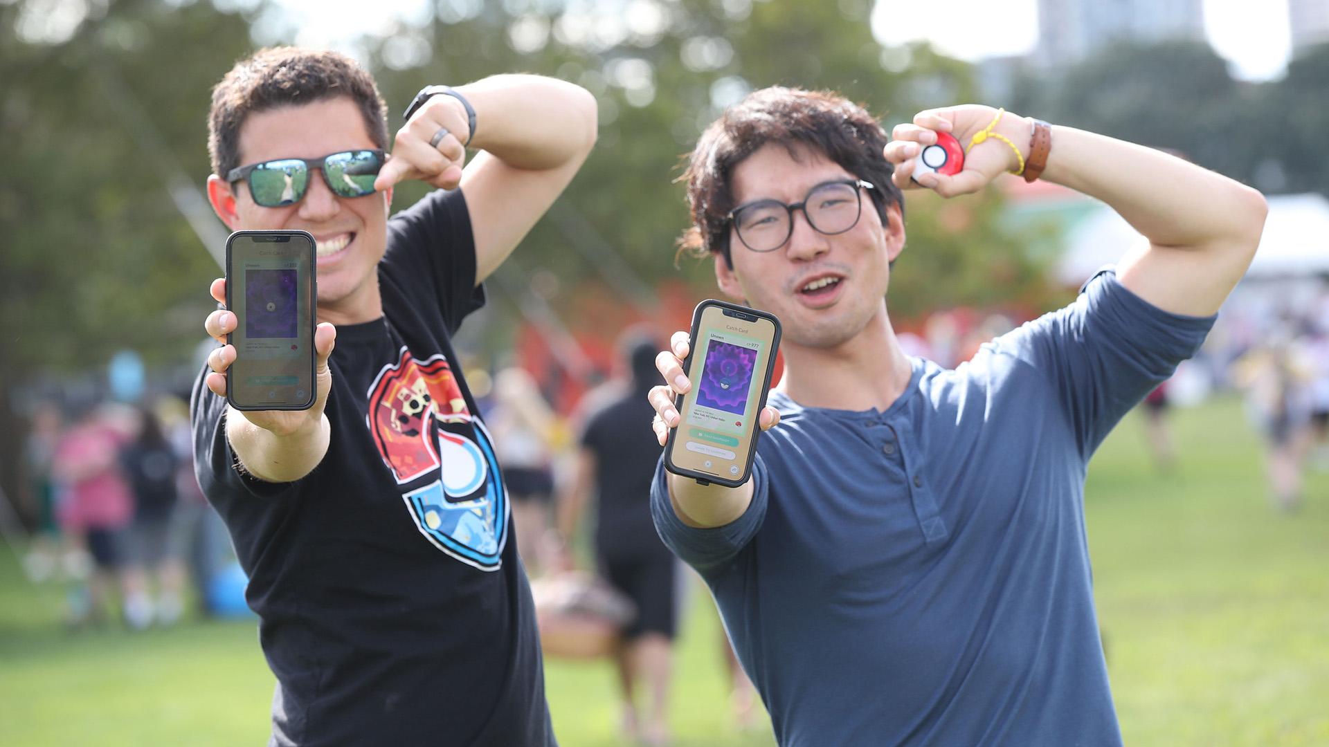 Two trainers showing off their catches at Pokémon GO Fest in NYC.