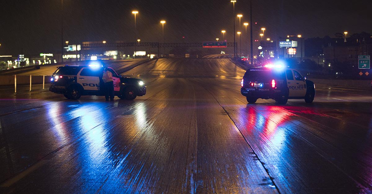 Houston police vehicles parked on a highway.