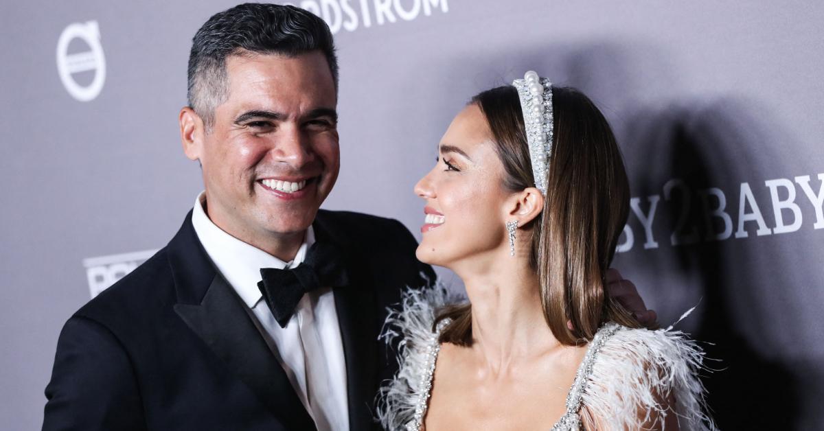 Jessica Alba smiles at Cash Warren on the red carpet at the 2019 Baby2Baby Gala in November 2019.