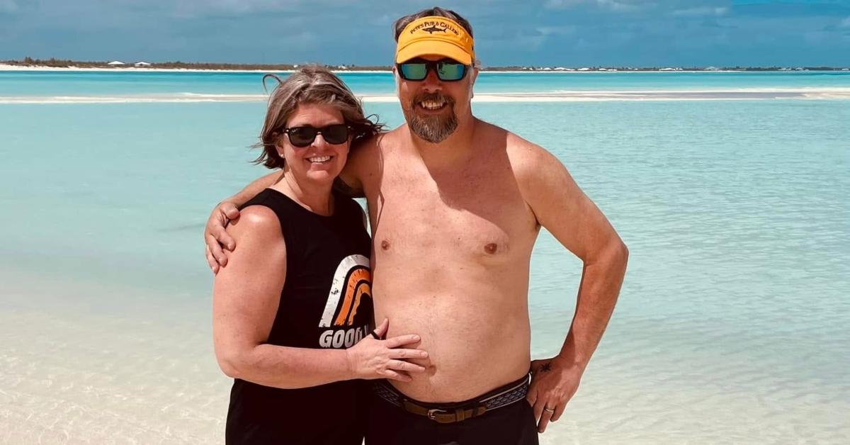 Dixie from Maine Cabin Masters with his wife on a beach.