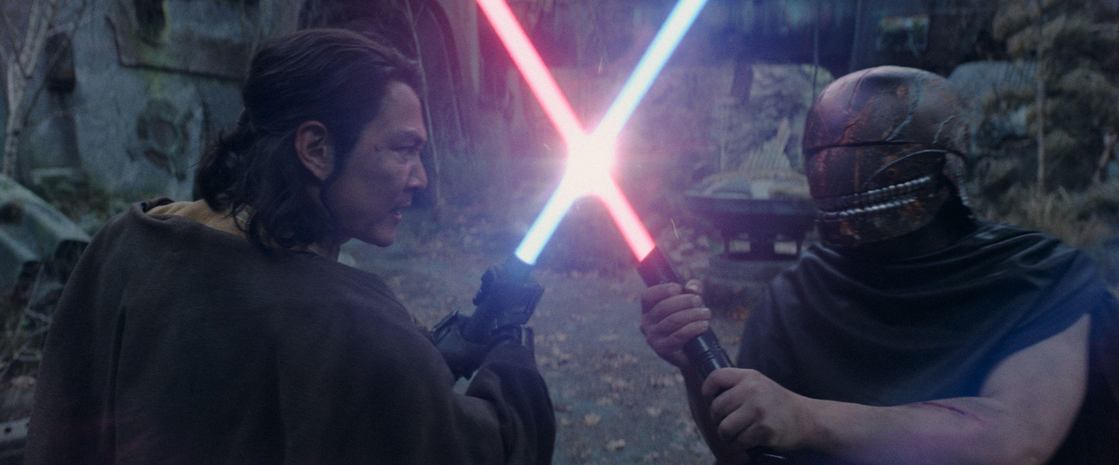 Two character crossing lightsabers in 'The Acolyte'