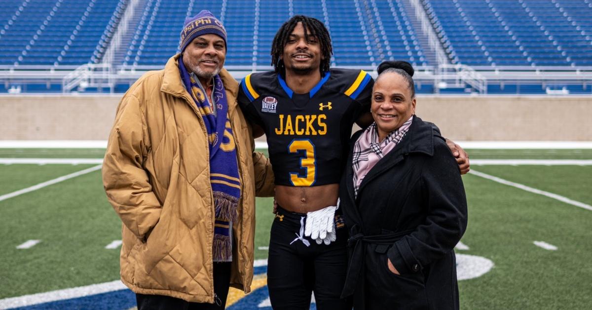 Nate White with his parents on the field
