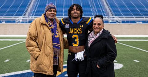 Nate White with his parents on the field
