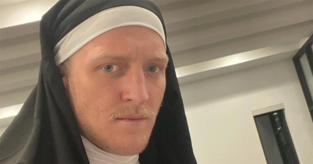 Tfue in a nun's outfit with a mustache. 