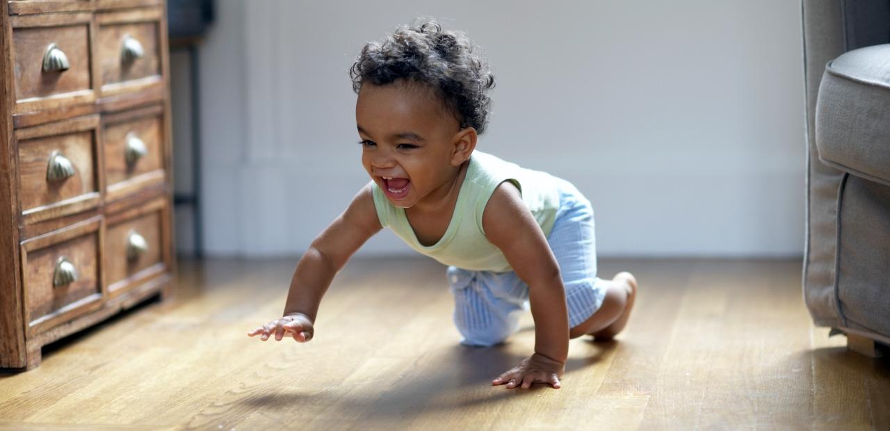 Baby boy crawling and smiling