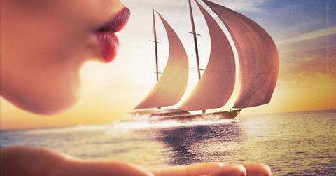 'Below Deck Sailing Yacht' Season four promotional image of a woman blowing the sails of a ship on the ocean