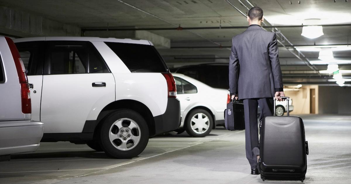 A man walking to a parked car