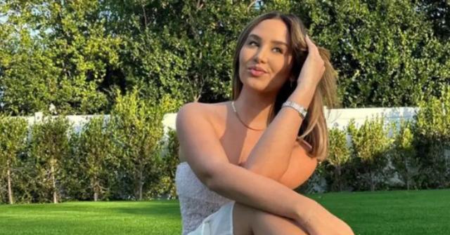 Catherine Paiz poses outside in a white dress