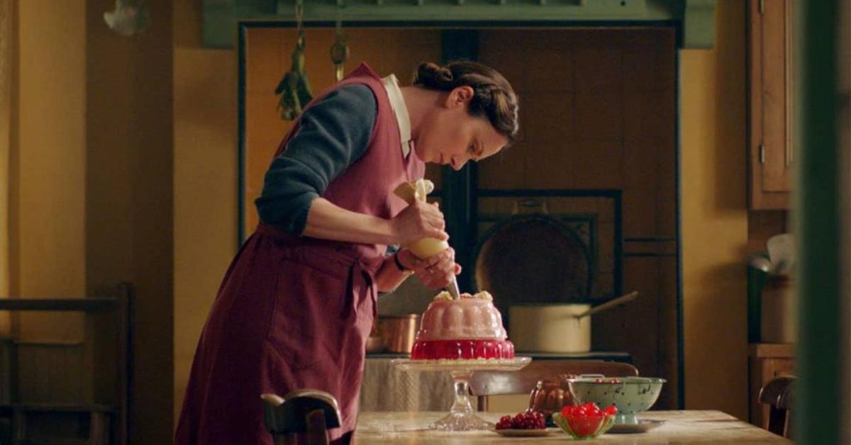 Mrs. Hall decorates a cake in All Creatures Great and Small.