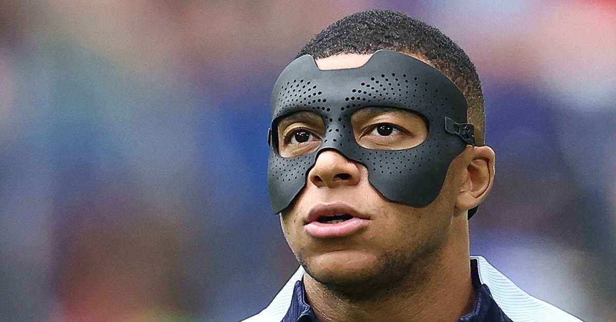 Kylian Mbappe, wearing a protective face mask, warms up ahead of the UEFA Euro 2024 round of 16 football match between France and Belgium