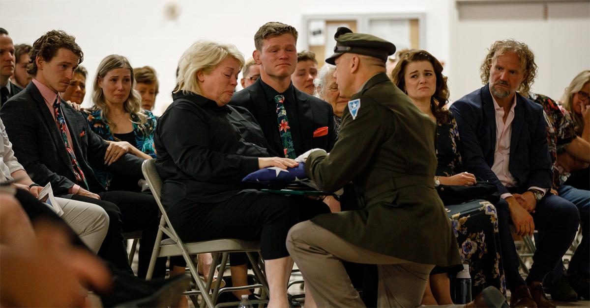 Garrison Brown's mother receiving the flag following his funeral. 