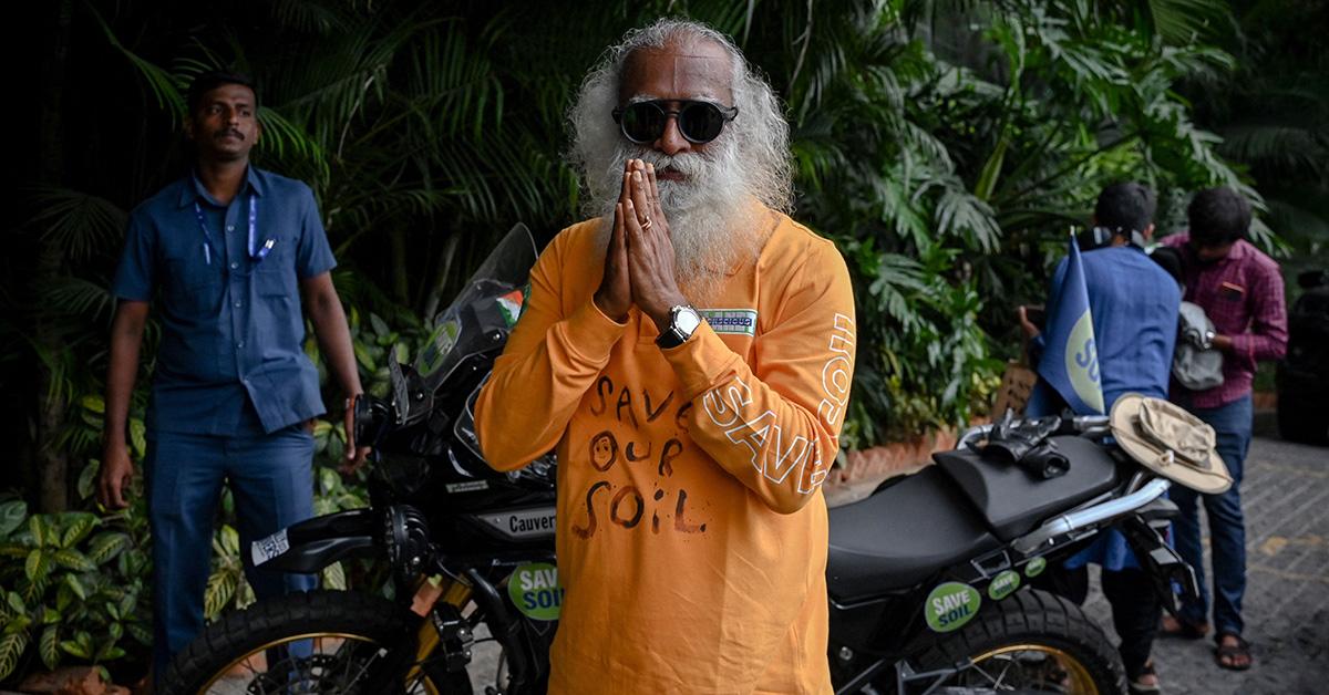 Sadhguru putting his hands together at an environmental rally. 