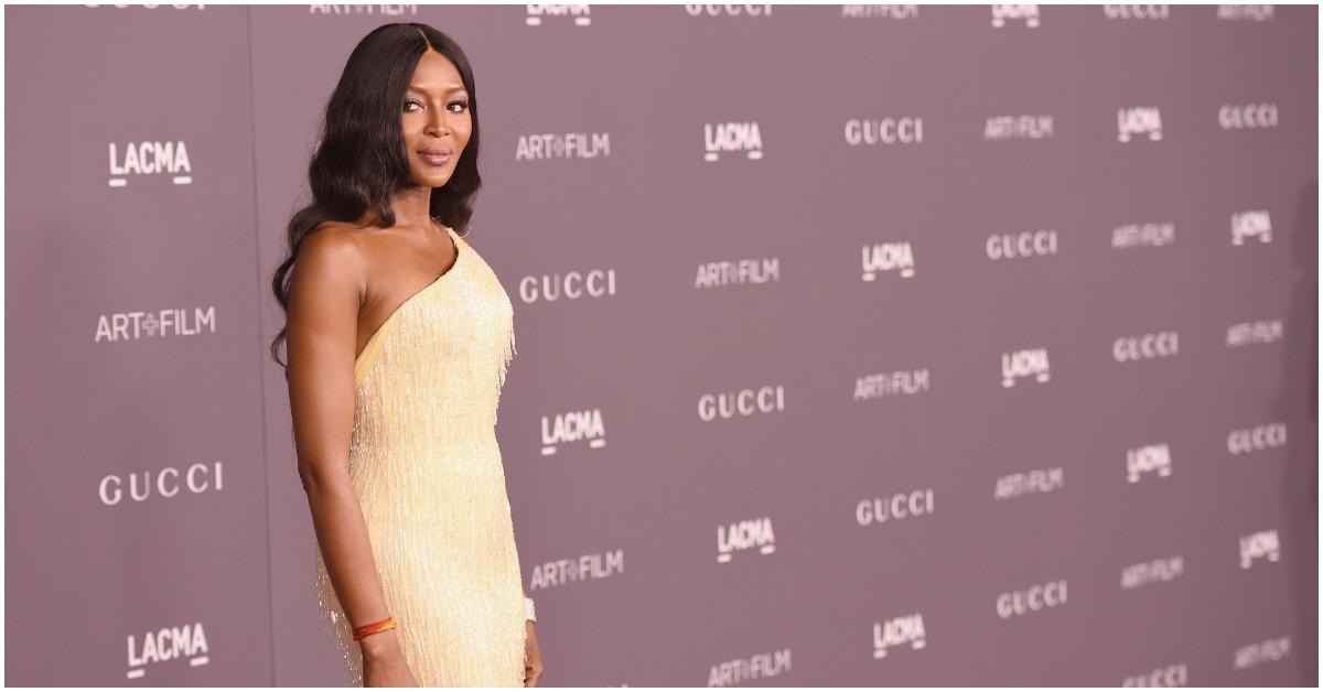 Naomi Campbell wearing a yellow dress on the red carpet.