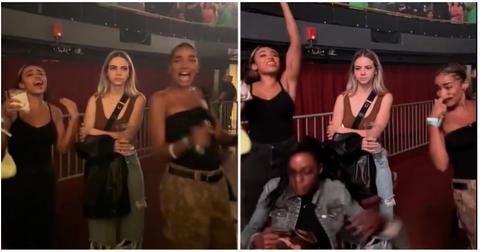 Bobbi Althoff looks unbothered as friends dance and cheer at a drake concert.