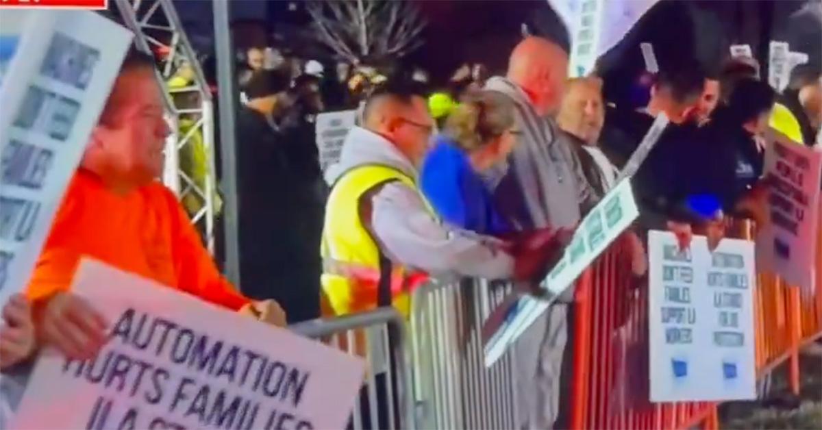 Striking dock workers behind a barrier on the east coast. 