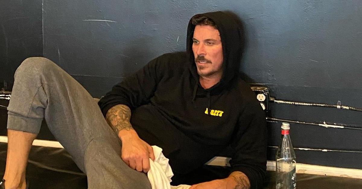 Jax Taylor sits on the floor at a gym