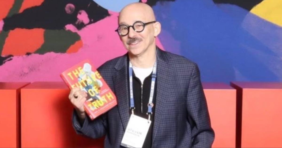 Steven Rosenbaum poses for a picture with his book "The Future of Truth: How AI Reshapes Reality."