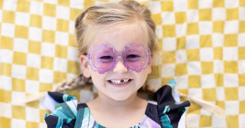 girl smiling with purple sunglasses