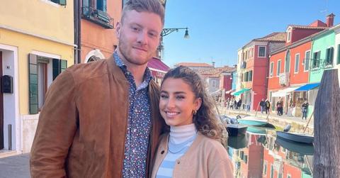 (L-R) Will Levis in a brown jacket and blue shirt, stands next to Gia Duddy in a blue and white shirt and khaki blazer