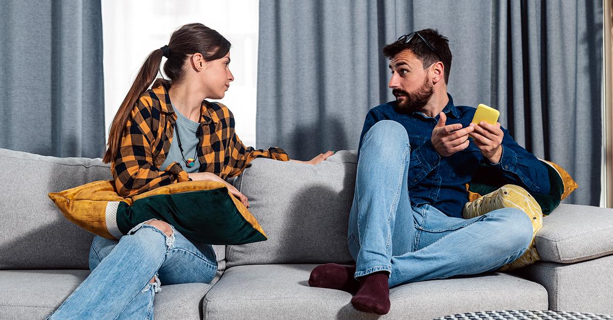 a man and woman arguing on a couch