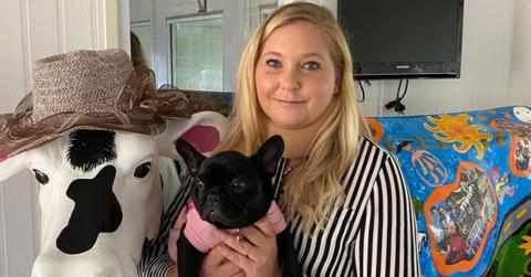 Virginia Giuffre holds a dog