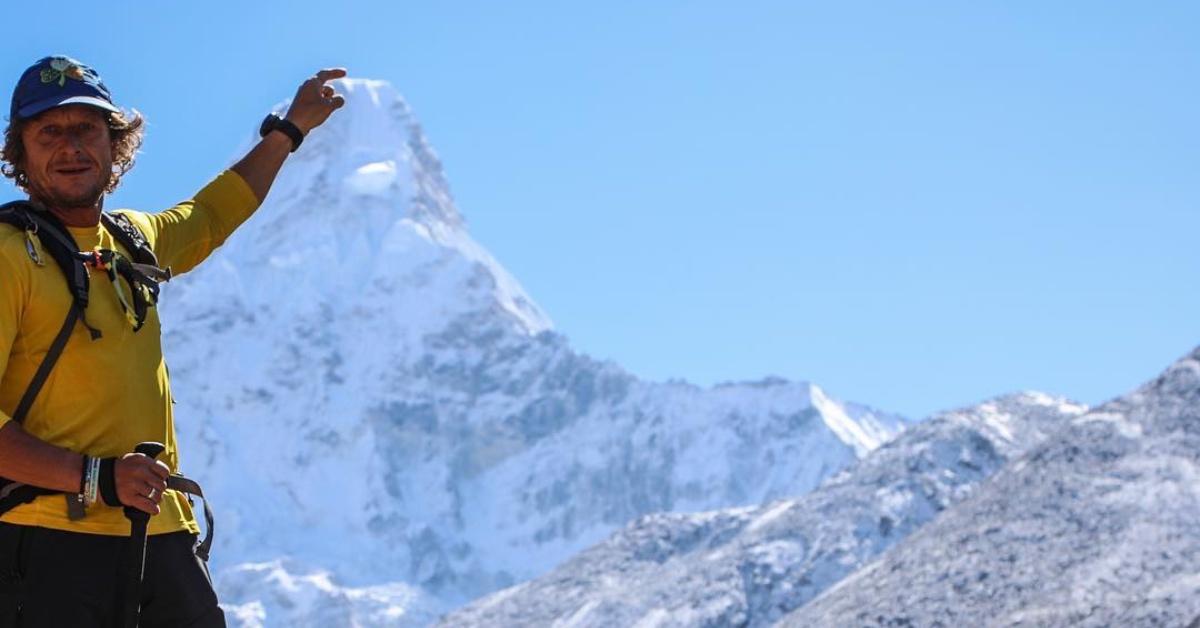 Noel Hanna posts a picture of himself pointing at a mountain peak in 2019.