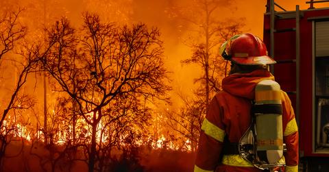 A firefighter looking at a fire.