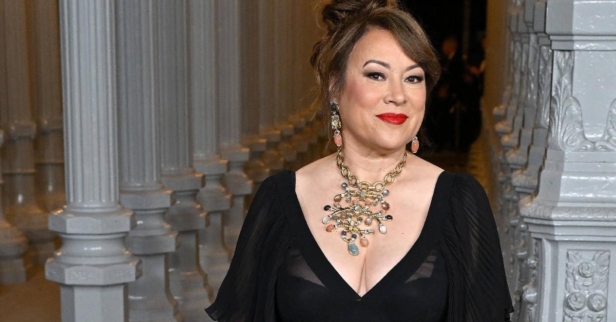 Jennifer Tilly wearing a black evening gown while standing outside