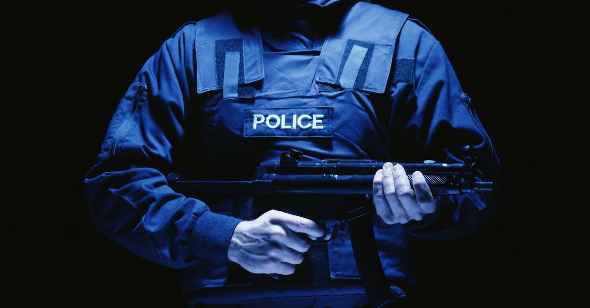 A police officer holding a gun