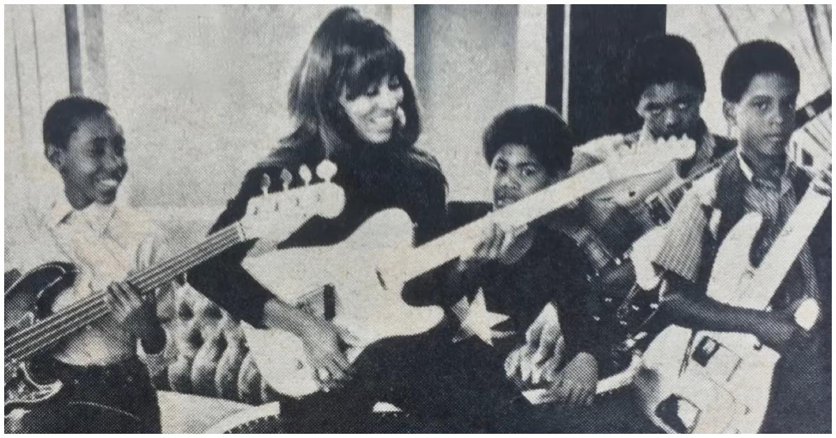 Tina Turner playing guitar with her sons